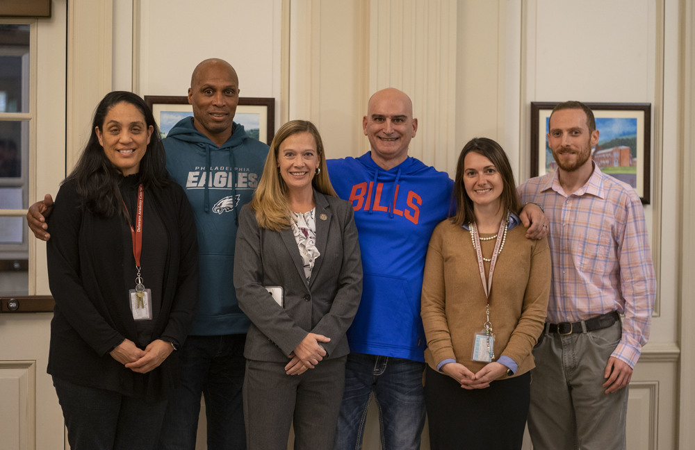 School administration and staff stand with former professional athletes  following the first of the school's guest speaker series.